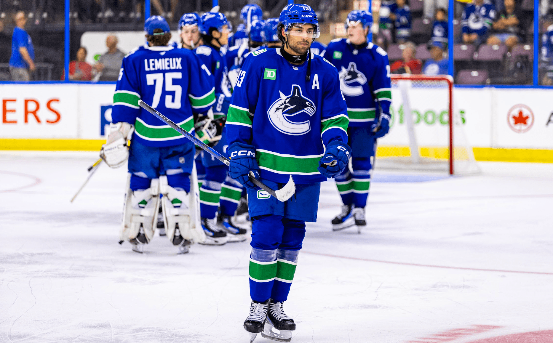 Arshdeep Bains skates away as his Vancouver Canucks teammates celebrate following a 2-0 victory over the Edmonton Oilers at the Young Stars Classic in Penticton, BC.