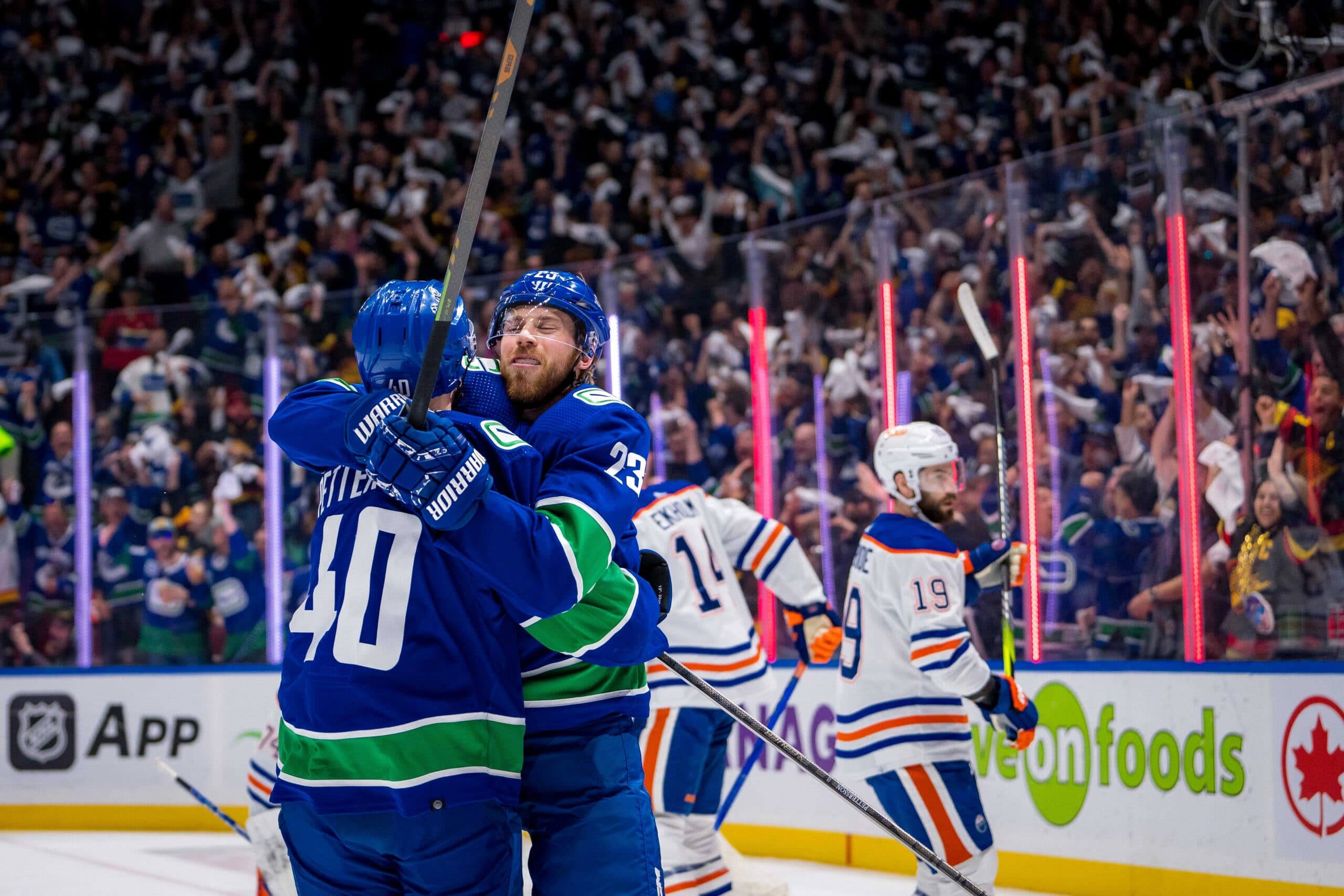 Elias Pettersson hugs Elias Lindholm Vancouver Canucks