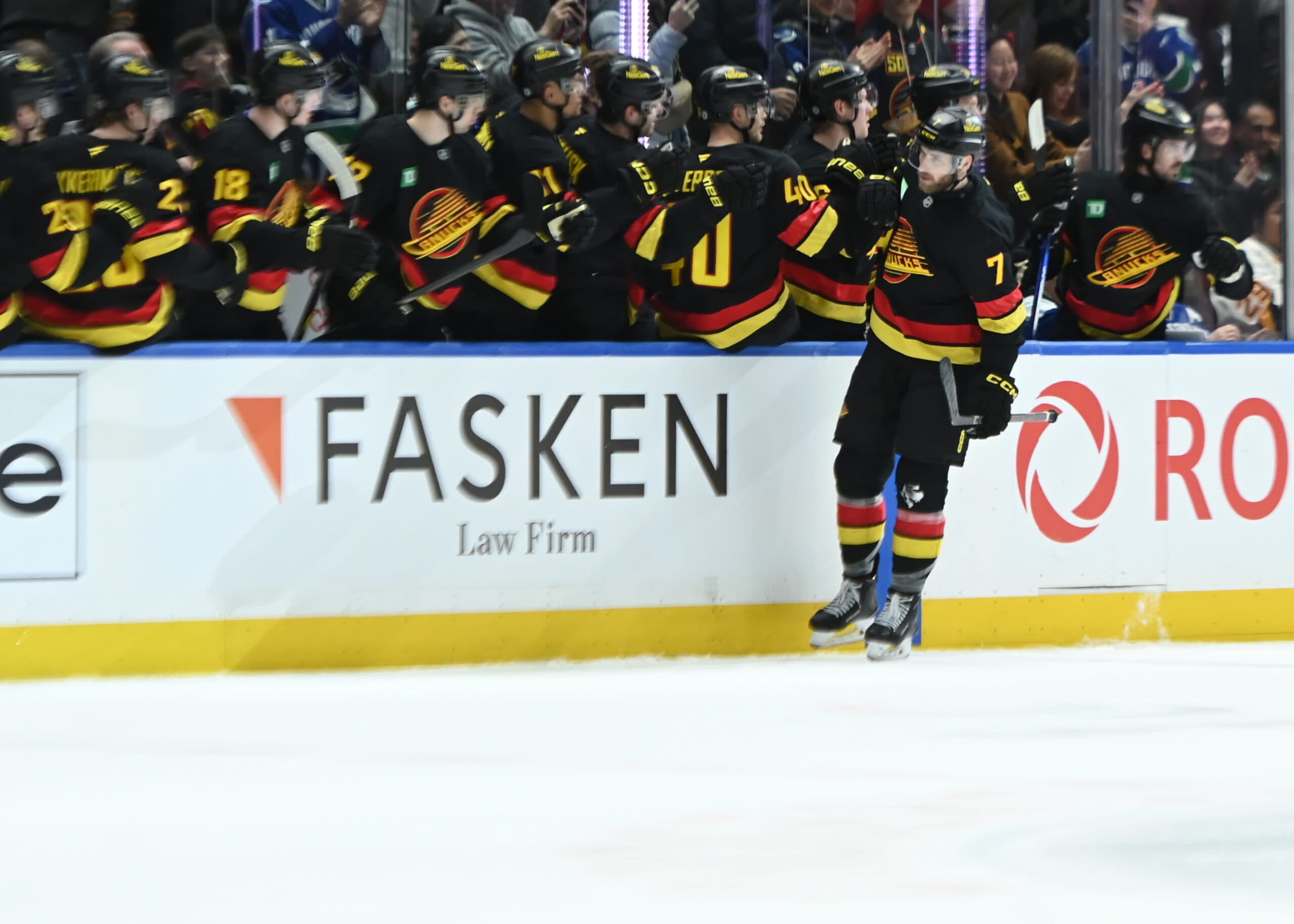 Carson Soucy skates by bench, Vancouver Canucks